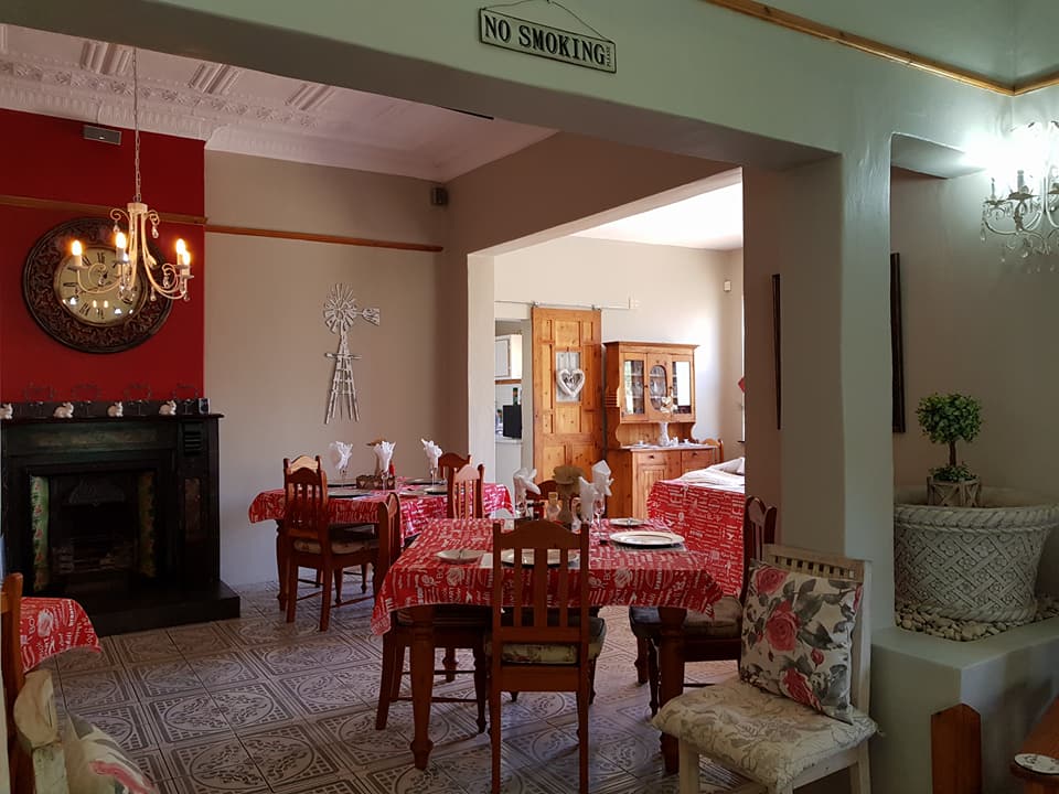 Dining room with an indoor fireplace at Oregon Cottage Guesthouse